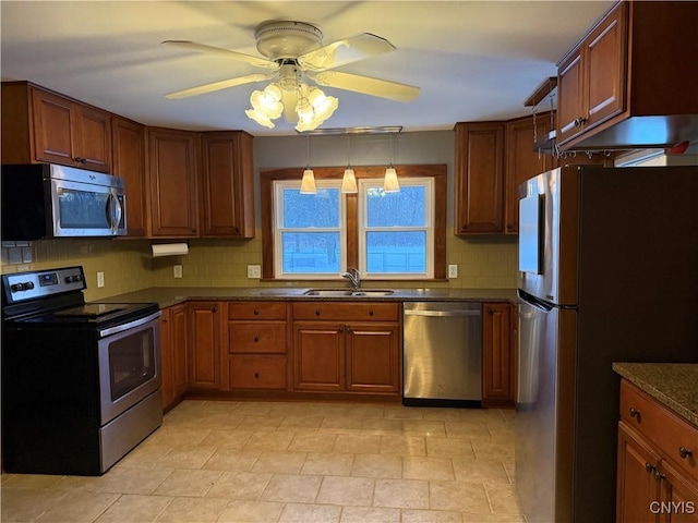 kitchen with appliances with stainless steel finishes, sink, dark stone counters, decorative backsplash, and ceiling fan