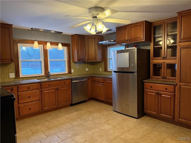 kitchen featuring pendant lighting, stainless steel appliances, sink, and backsplash