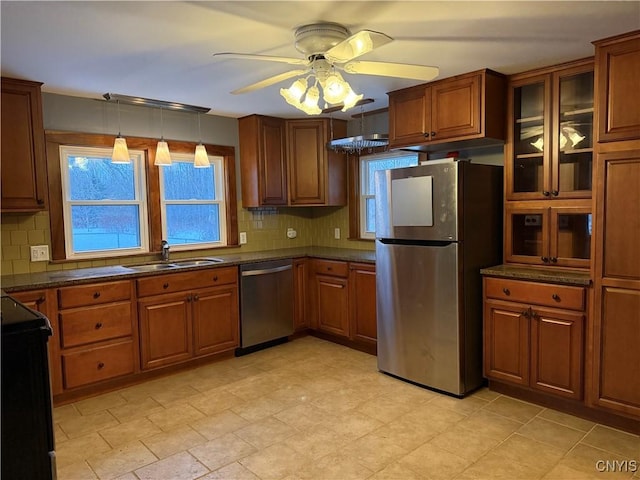 555 County Route 51, New Haven, NY 13114 - kitchen with stainless steel appliances, a sink, a ceiling fan, decorative backsplash, and brown cabinetry