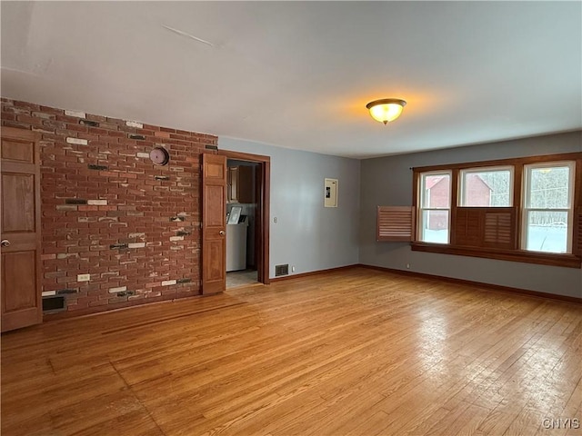 555 County Route 51, New Haven, NY 13114 - empty room featuring light wood finished floors, baseboards, and washer / clothes dryer