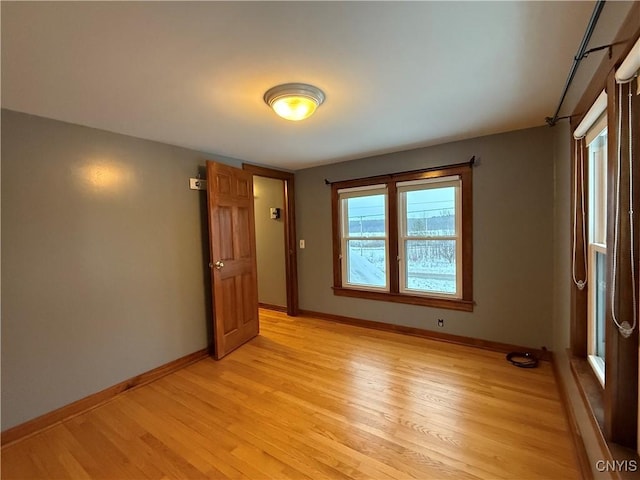 unfurnished room with light wood-type flooring