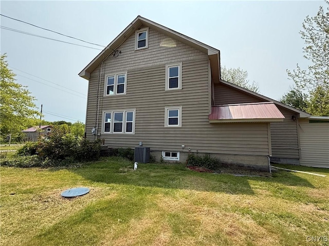 555 County Route 51, New Haven, NY 13114 - rear view of house with central AC unit, a yard, and metal roof