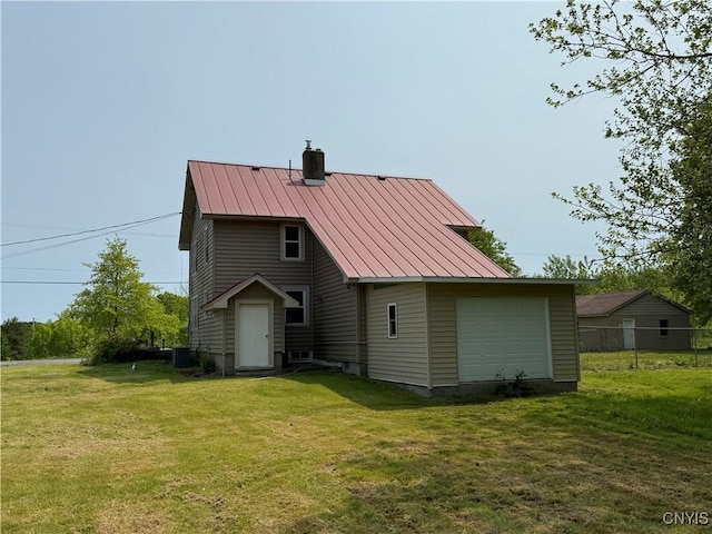 555 County Route 51, New Haven, NY 13114 - back of house featuring a chimney, metal roof, a standing seam roof, a detached garage, and central air condition unit