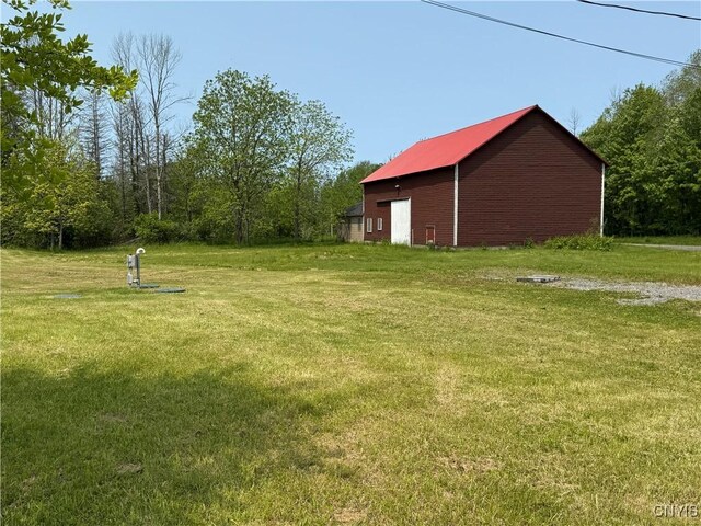 555 County Route 51, New Haven, NY 13114 - view of green lawn with an outbuilding and a detached garage