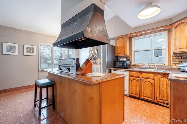 kitchen with sink, light tile patterned floors, stainless steel fridge, dishwasher, and island exhaust hood