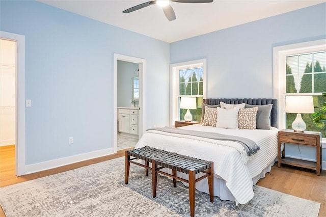 bedroom featuring hardwood / wood-style flooring, ceiling fan, and ensuite bathroom