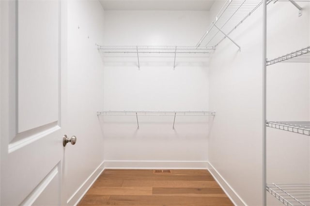 walk in closet featuring hardwood / wood-style floors