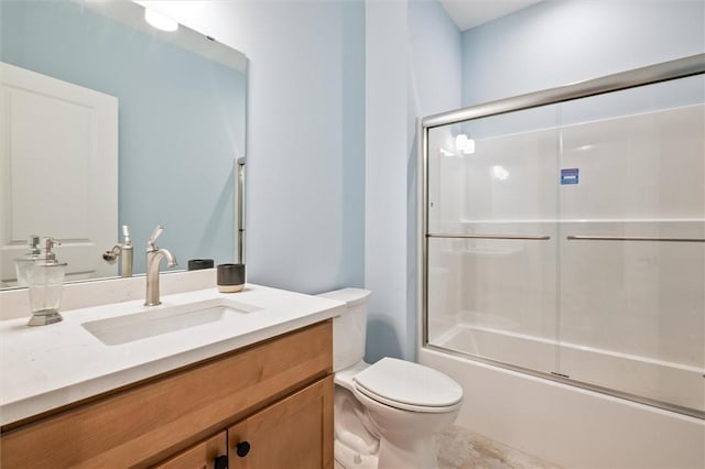 full bathroom with vanity, enclosed tub / shower combo, and toilet