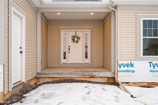 view of snow covered property entrance