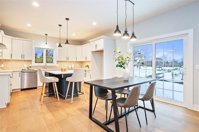 dining space featuring sink and light wood-type flooring