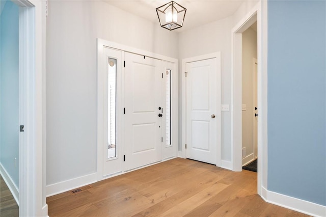 foyer entrance with light wood-type flooring