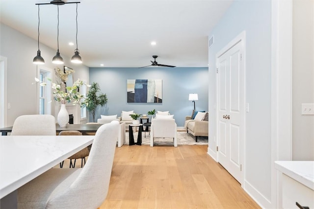 dining room featuring ceiling fan and light wood-type flooring