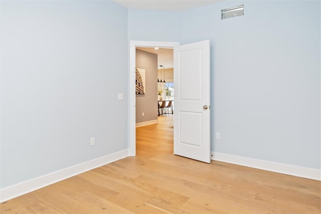 spare room with light hardwood / wood-style flooring