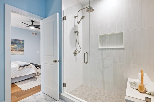 bathroom featuring an enclosed shower and ceiling fan