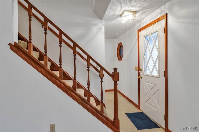 entrance foyer with a textured ceiling