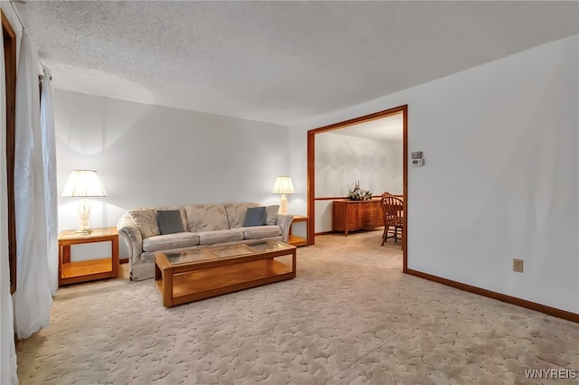 living room featuring light carpet and a textured ceiling