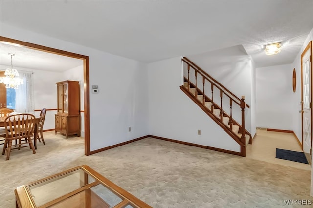 living room with a notable chandelier and carpet flooring