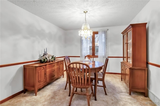 carpeted dining area featuring a chandelier and a textured ceiling