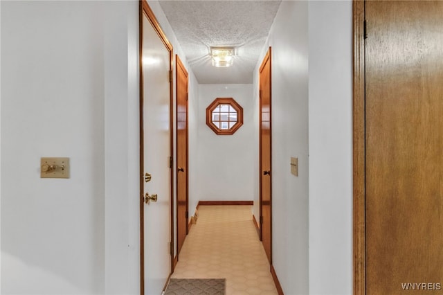 hallway featuring a textured ceiling