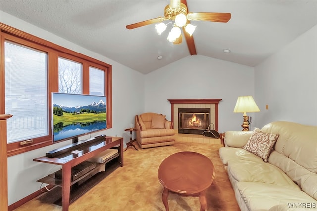 living room featuring plenty of natural light, vaulted ceiling with beams, light colored carpet, and a fireplace