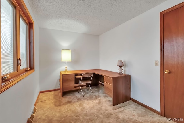 office area with light carpet and a textured ceiling