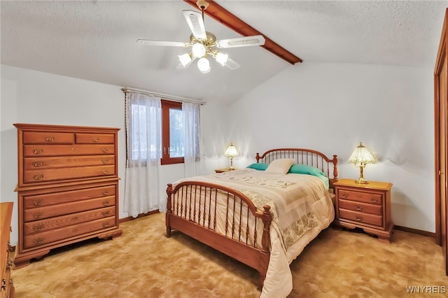 carpeted bedroom with lofted ceiling with beams, ceiling fan, and a textured ceiling