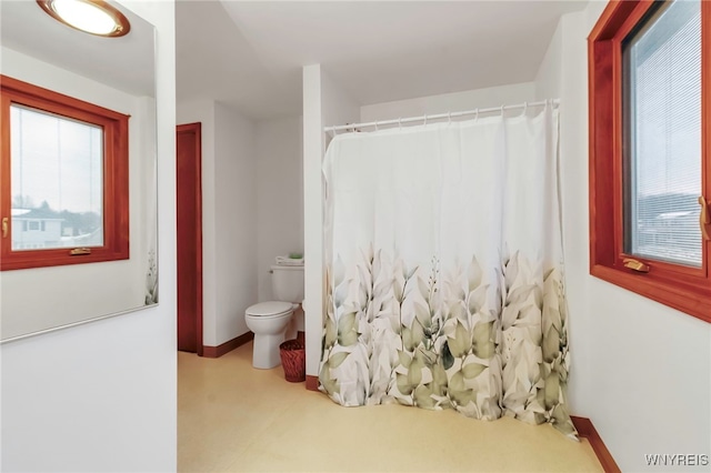 bathroom with toilet and walk in shower