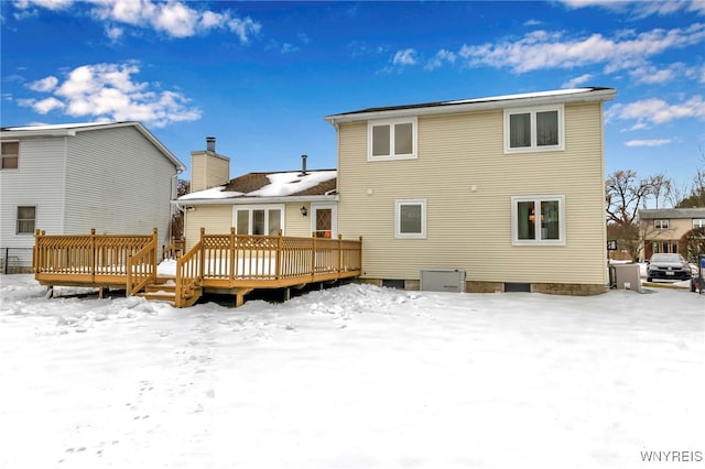 snow covered property featuring a wooden deck