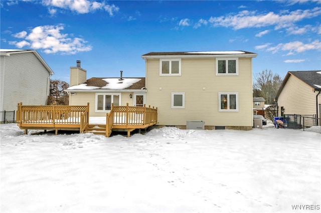 snow covered property featuring a wooden deck