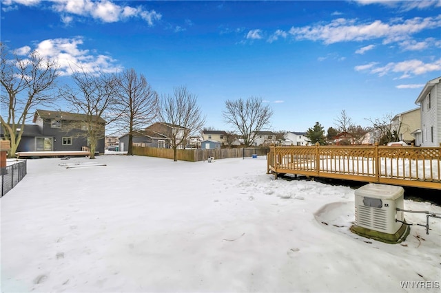 yard covered in snow with a deck