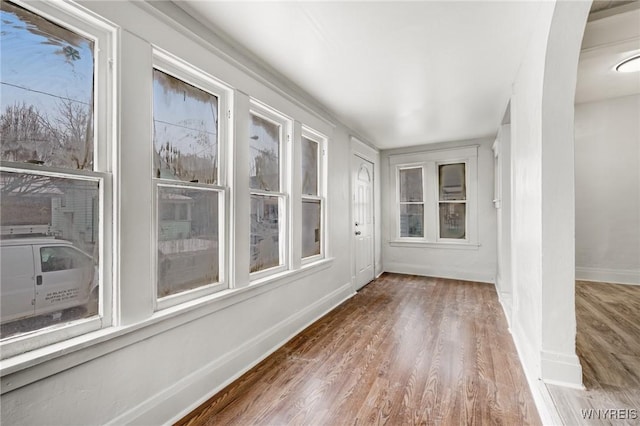 unfurnished sunroom featuring a healthy amount of sunlight