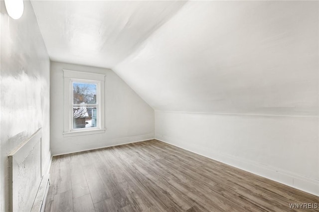 bonus room featuring wood-type flooring and lofted ceiling