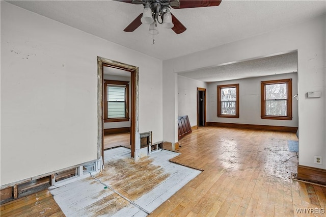 unfurnished room featuring hardwood / wood-style flooring and a textured ceiling