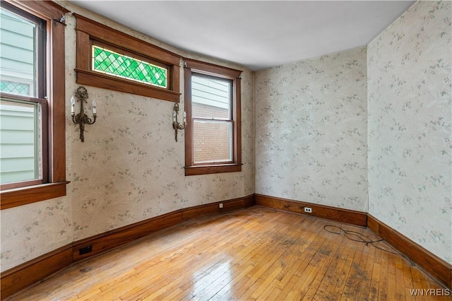 unfurnished room with wood-type flooring