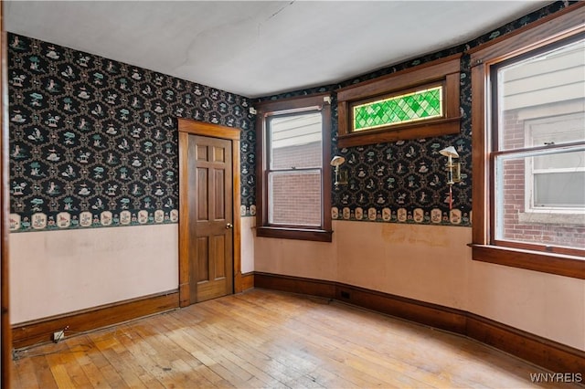 unfurnished room with light wood-type flooring