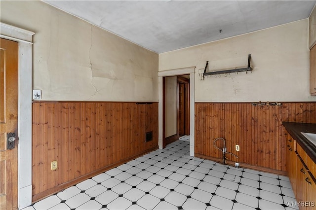 spare room featuring wooden walls