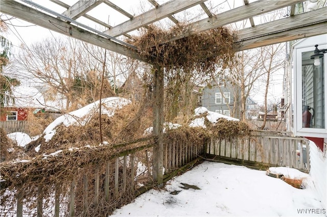 snowy yard with a pergola