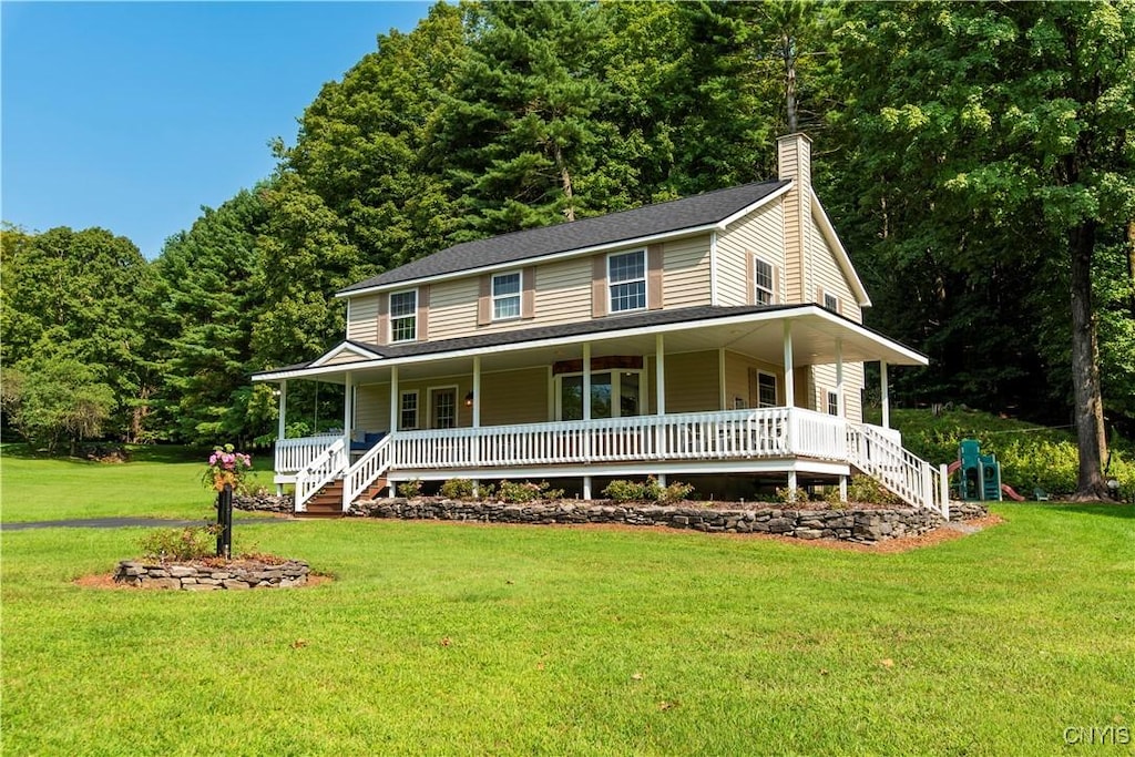 farmhouse with covered porch and a front lawn