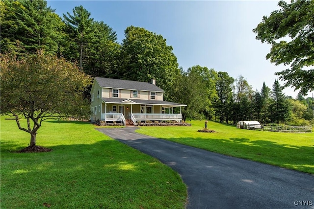 farmhouse with a porch and a front yard