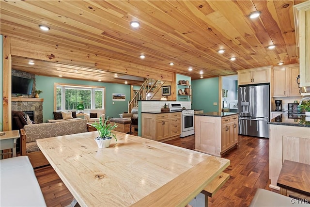 kitchen with a kitchen island, sink, stainless steel appliances, light brown cabinets, and wooden ceiling