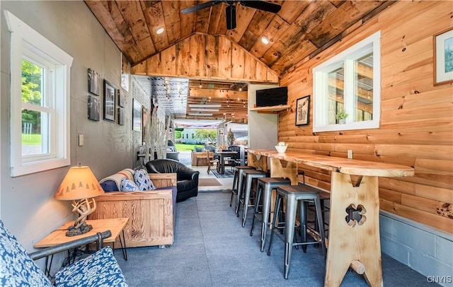 living room with vaulted ceiling, wooden ceiling, and ceiling fan