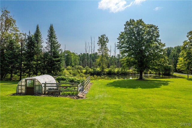 view of yard with an outdoor structure and a water view