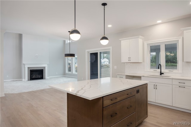 60 Woodthrush Trl, Orchard Park, NY 14127 - kitchen featuring sink, white cabinetry, a center island, pendant lighting, and backsplash