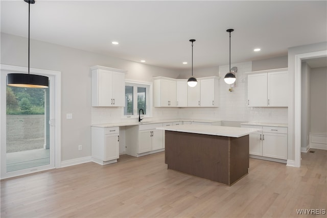 60 Woodthrush Trl, Orchard Park, NY 14127 - kitchen with pendant lighting, sink, a kitchen island, and white cabinets