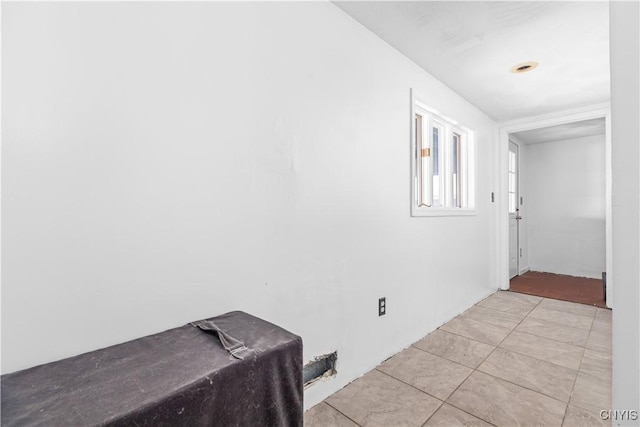 hall featuring light tile patterned floors