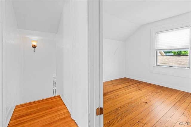 bonus room with lofted ceiling and light hardwood / wood-style flooring