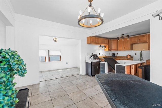 kitchen featuring an inviting chandelier, decorative light fixtures, a center island, and light tile patterned floors