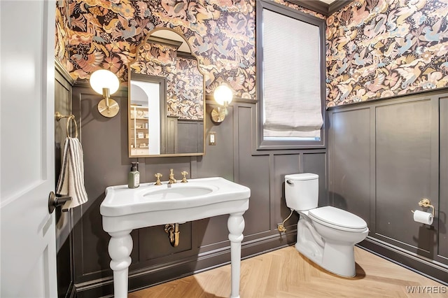 bathroom with parquet flooring and toilet