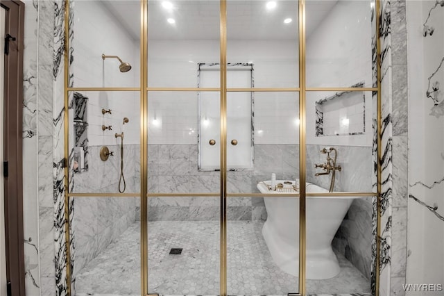 bathroom featuring separate shower and tub