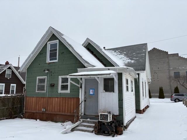 view of snow covered rear of property